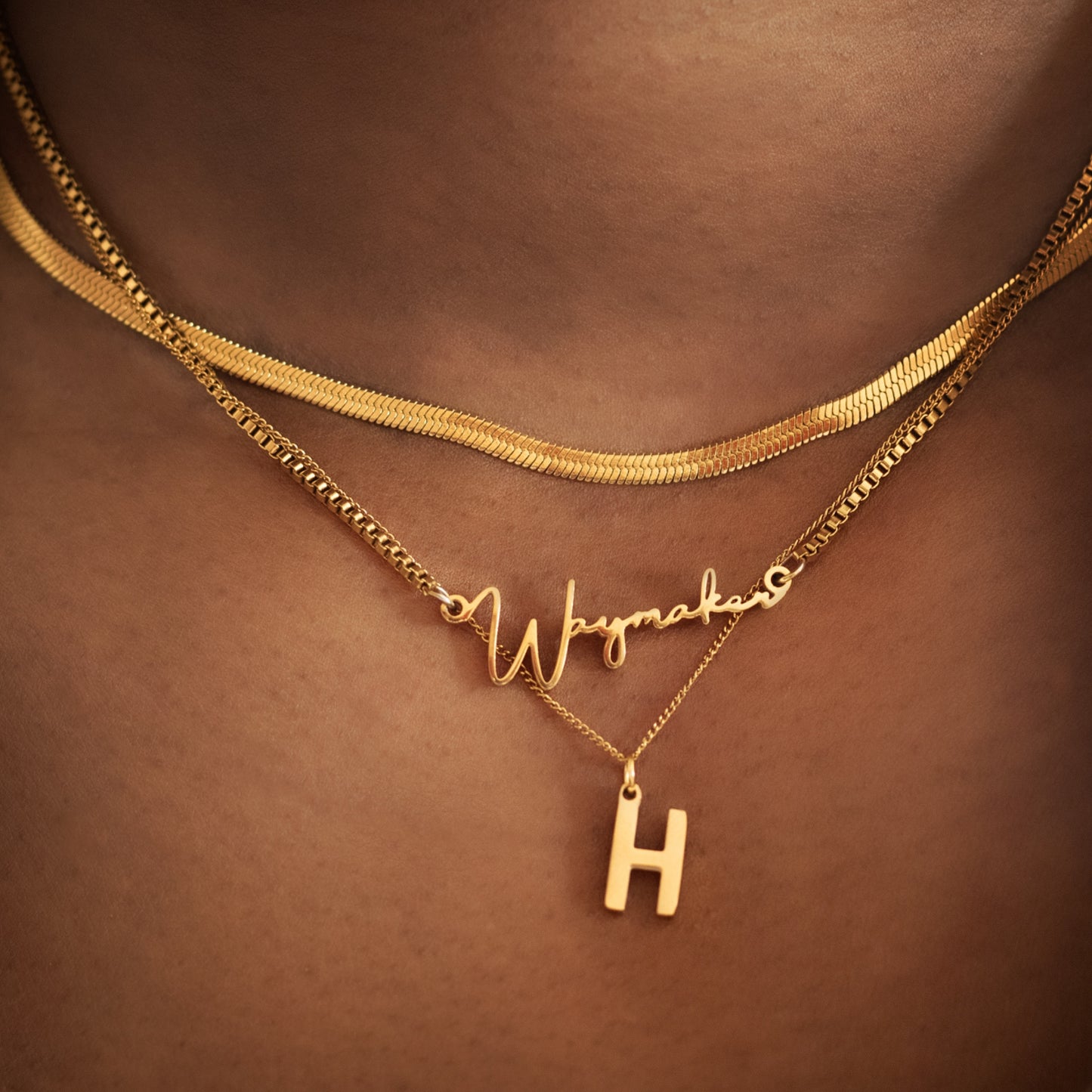 Gold initial charm pendant displayed on a dainty chain, showcasing a personalised letter design, perfect for layering or wearing alone as a meaningful Christian jewellery piece