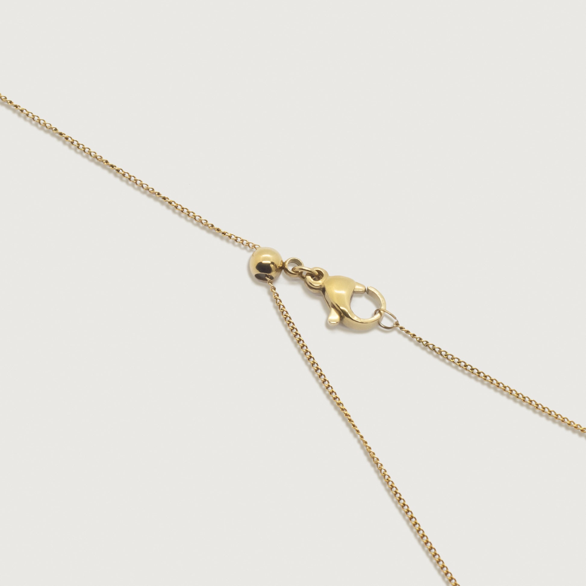 Up close view of the adjustable dainty cable necklace showcasing the fine craftsmanship with of the elegant adjustable clasp.